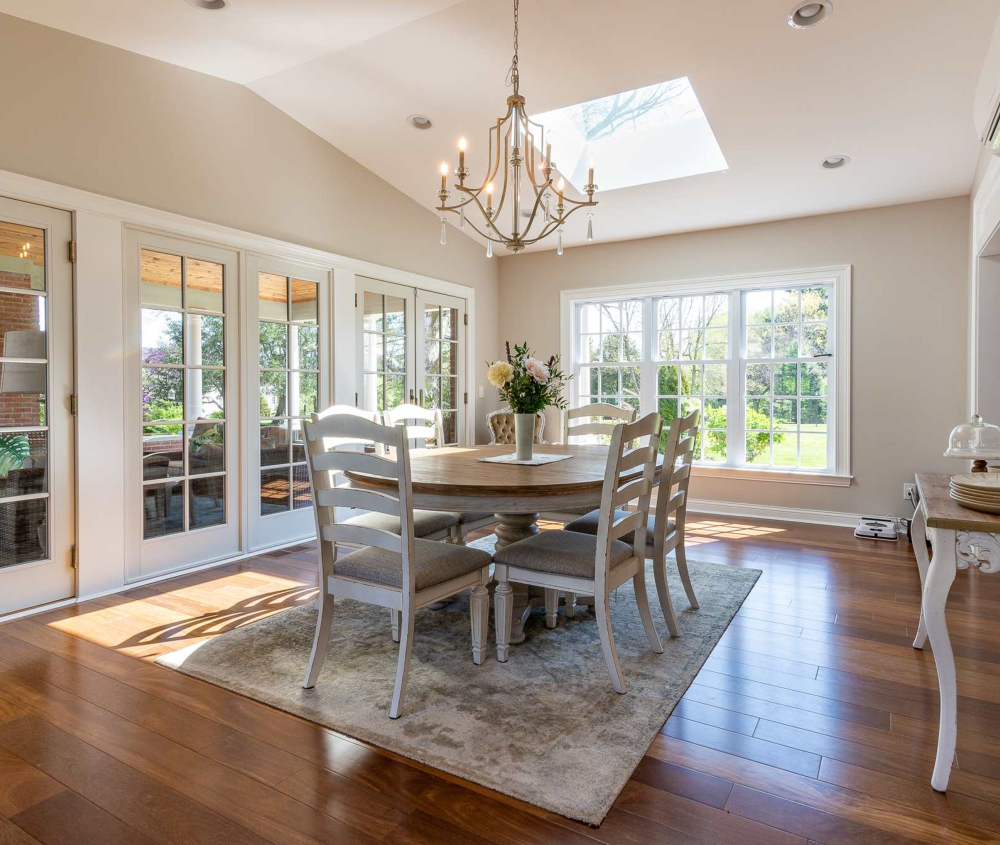 A bright dining room addition with a vaulted ceiling and skylight.